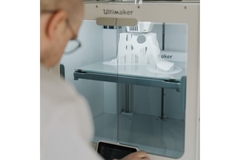 Man working on a 3D printer.
